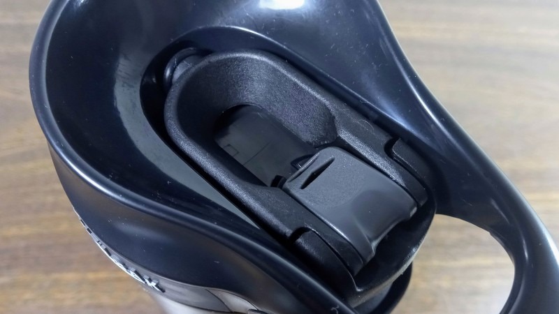 the arms in the open position, with the lock button in place to keep it from closing the spout
