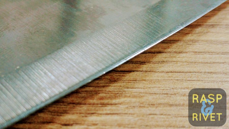 One of the meat cleaver’s edges before sharpening with the Lansky. One of the meat cleaver's edges before sharpening with the Lansky.