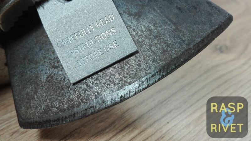 One side of the axe head before sharpening. One side of the axe head before sharpening.