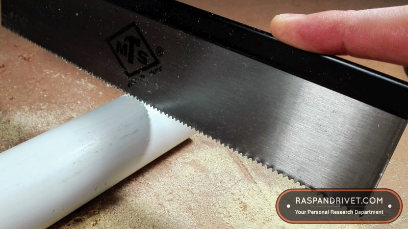 Starting a cut on PVC pipe with a standard backsaw. Starting a cut on PVC pipe with a standard backsaw.