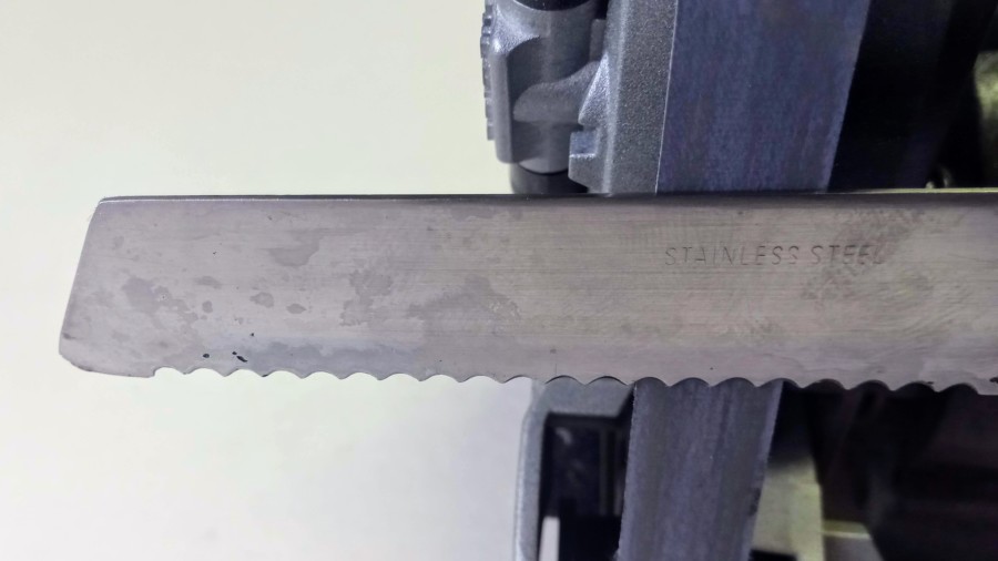 This serrated knife’s bevel is on the left hand side, which means I had to use the machine the wrong way around to sharpen the flat side. This serrated knife's bevel is on the left hand side, which means I had to use the machine the wrong way around to sharpen the flat side.